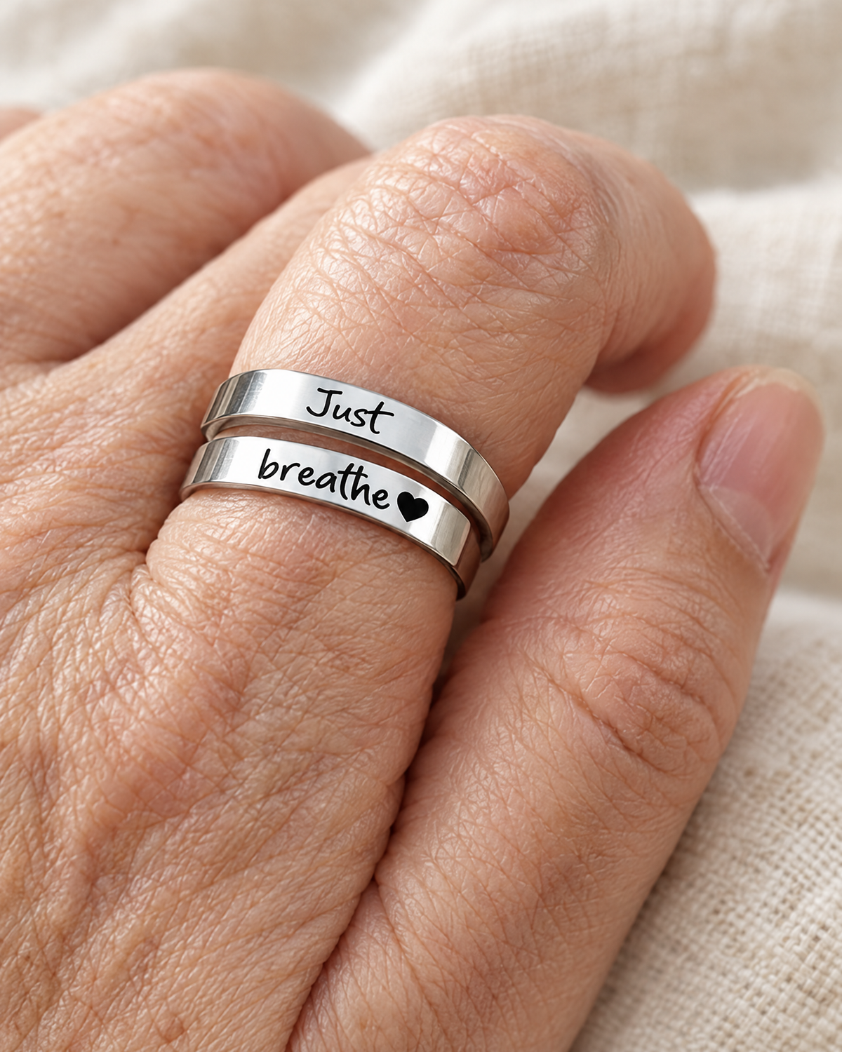 The Breathe Ring worn on the finger, Just breathe readable