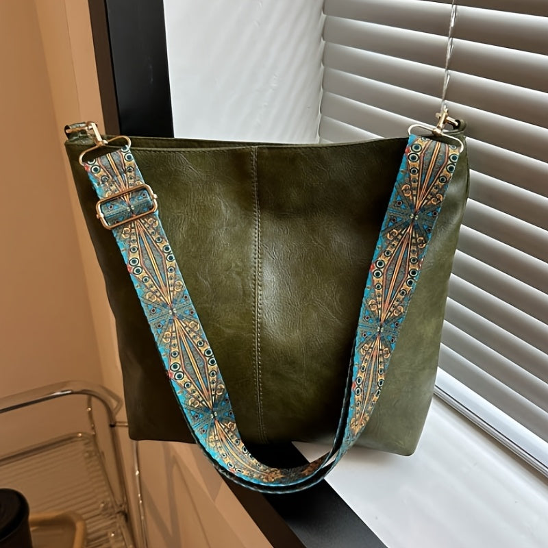 The Sienna Bag in green, by the window